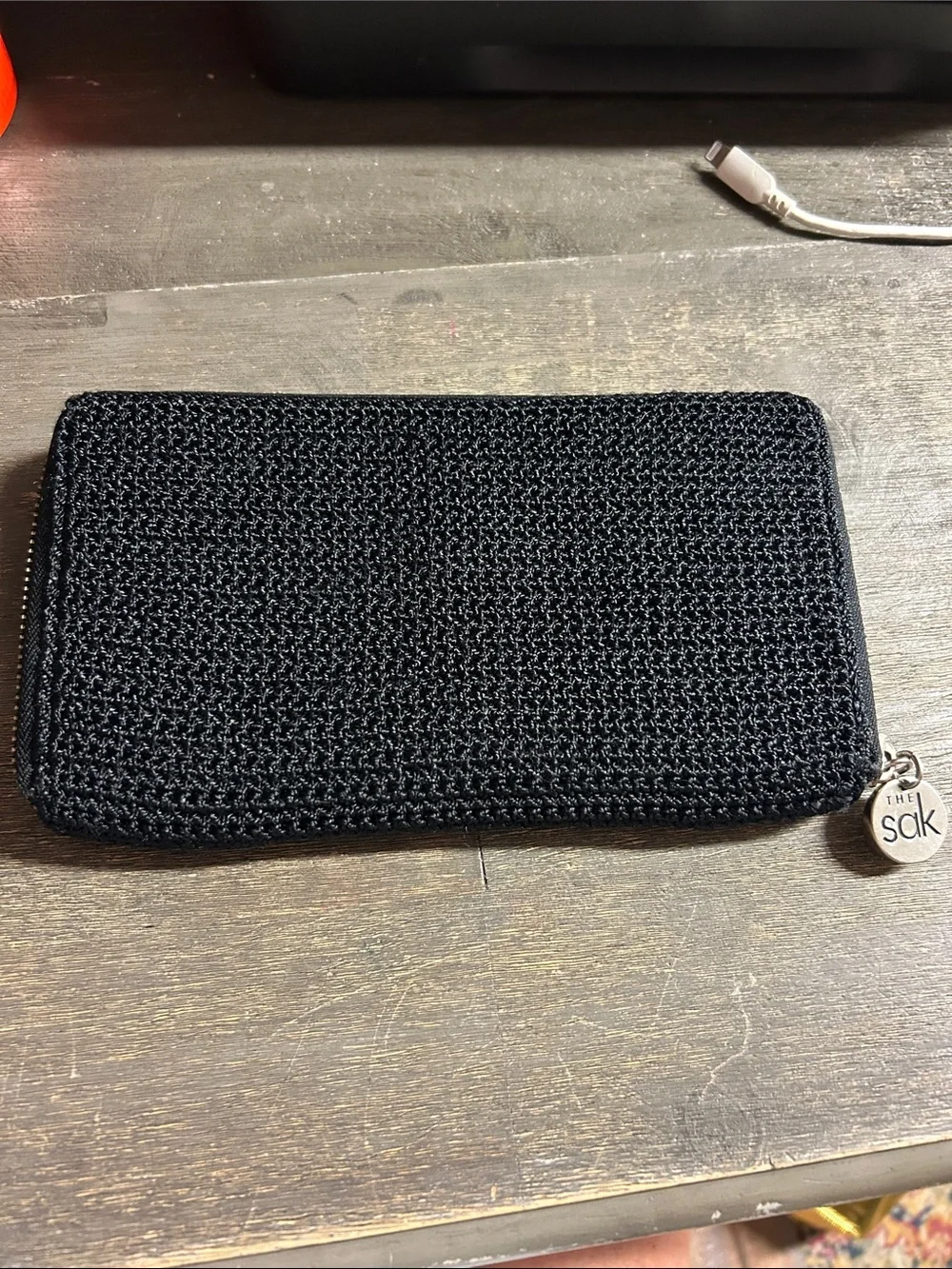 The Sak Black Crochet Zip Wallet with Logo Charm Accordion Style